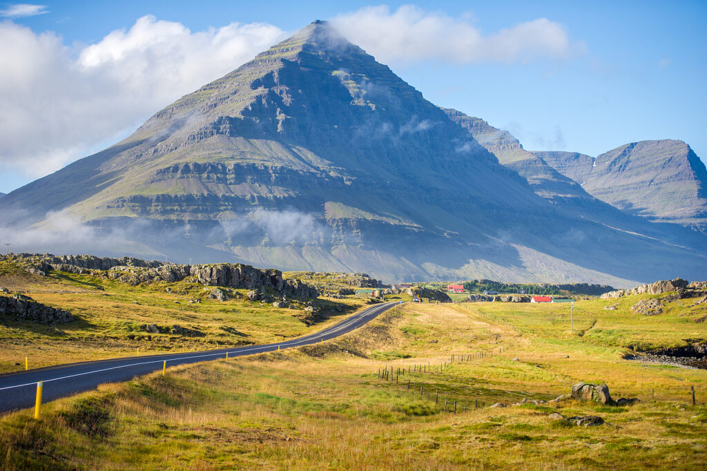 A view of Iceland’s Ring Road with a mountain looming in the background.